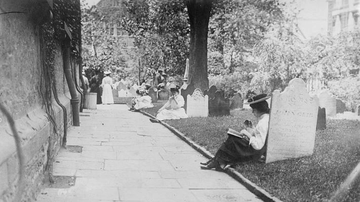 Archival photo of women in Victorian times, relaxing among the gravestones