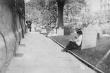 Archival photo of women in Victorian times, relaxing among the gravestones