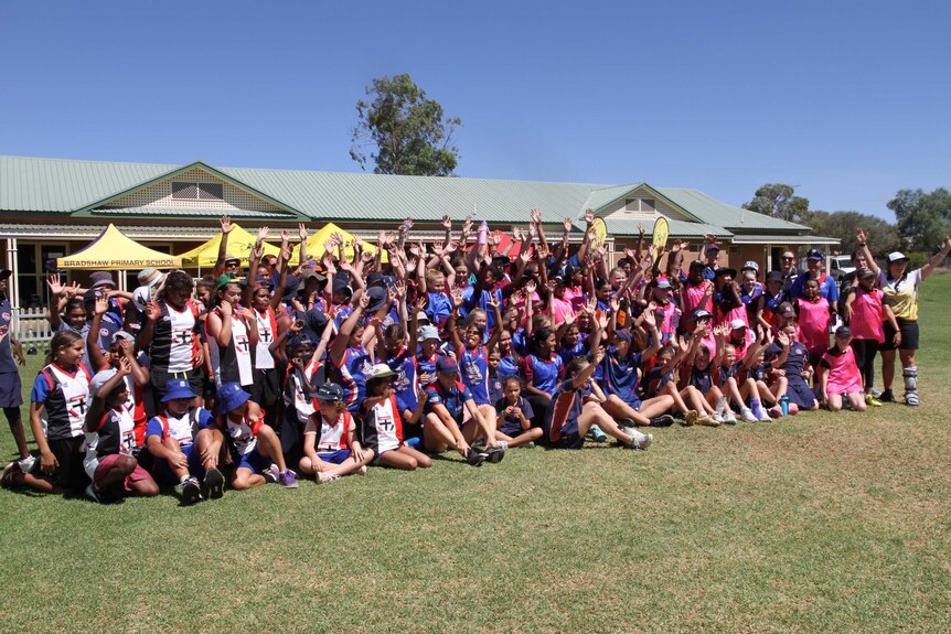 A large group of girls gather for a photo.