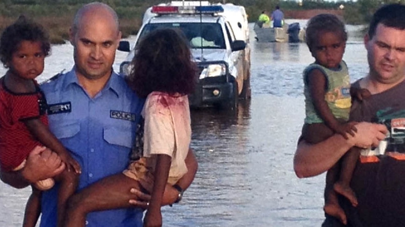 Police officers rescue children from floodwaters