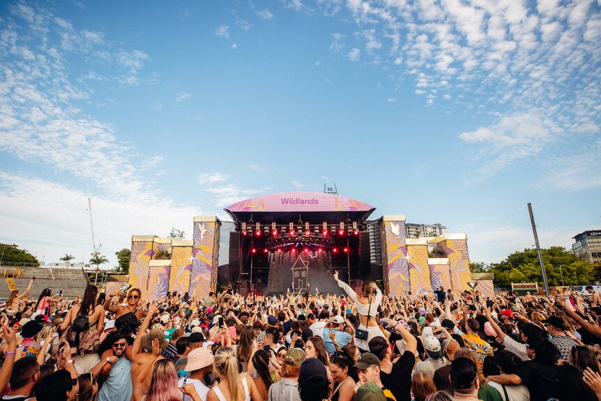 Daytime photo of Wildlands Festival stage with a large crowd in front of it