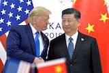 US President Donald Trump, left, shakes hands with Chinese President Xi Jinping.