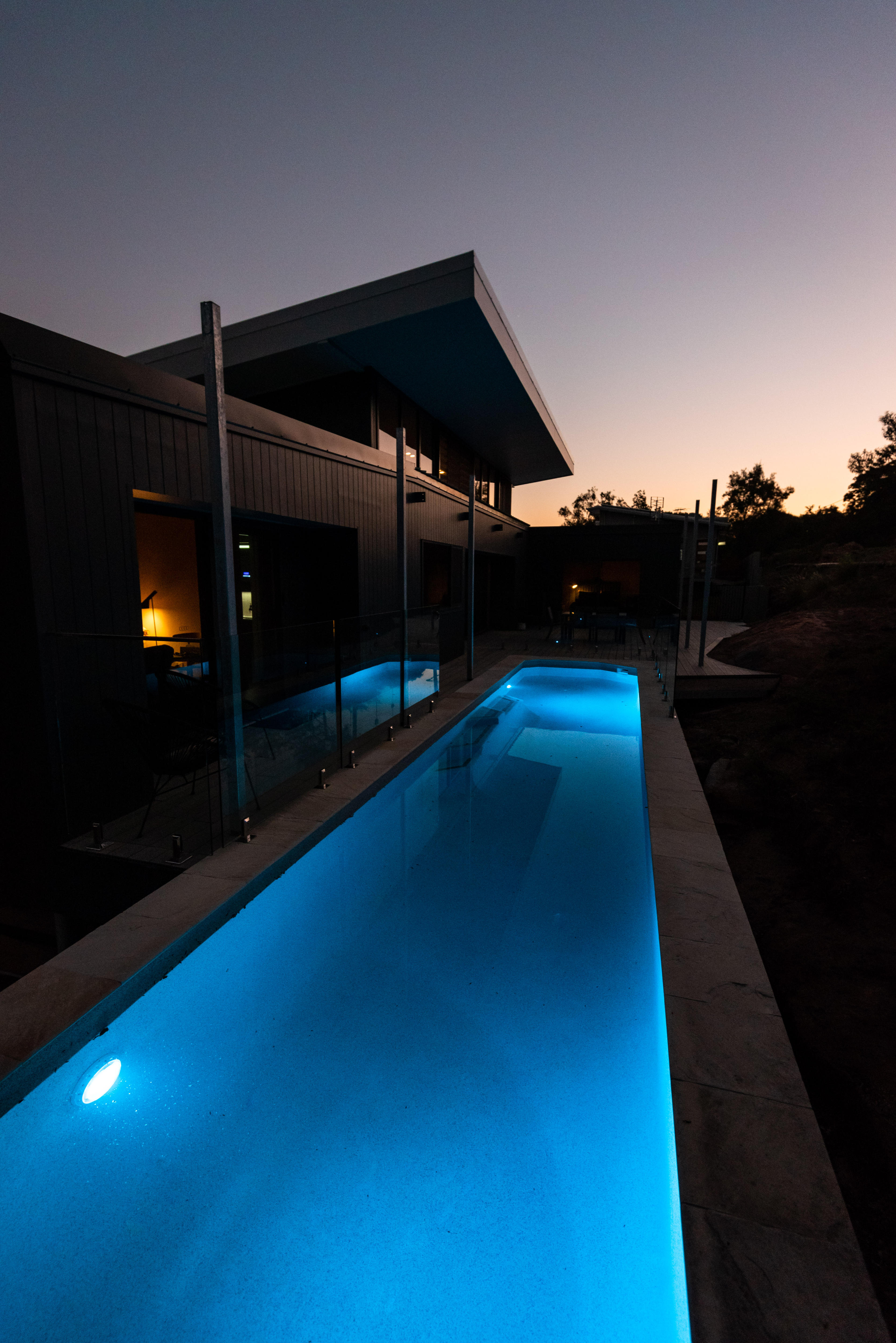 A long, narrow pool with blue lights. 