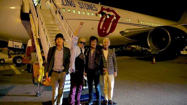 Rolling Stones with plane in the background with logo.