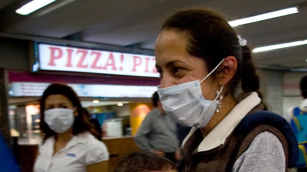 A woman and her baby wear face masks as prevention against the swine flu virus in Mexico City