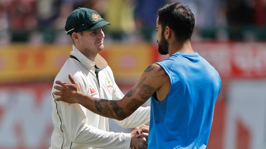 Australia captain Steve Smith, (L) and his India counterpart Virat Kohli shake hands in Dharamsala.