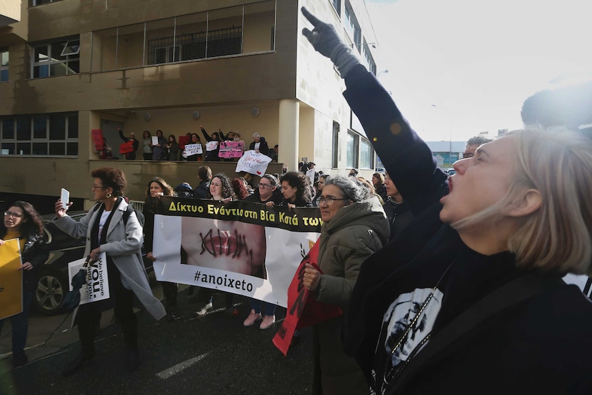 Protesters supporting the 19-year-old British woman outside of a court in Cyprus.