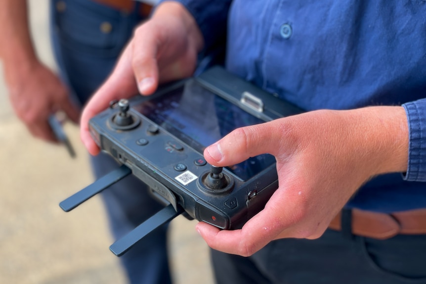 close up of hands on a drone controller