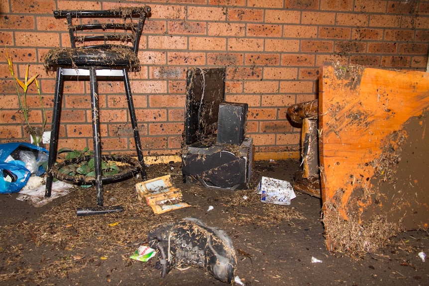 Personal items covered in dirt and debris in a Dungog resident's house