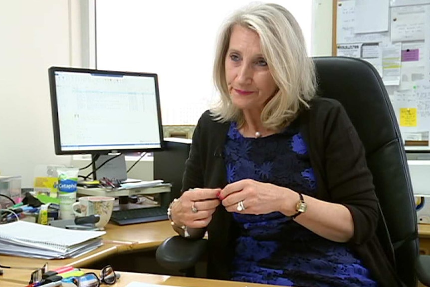 Zana Bytheway sits at her desk in her office