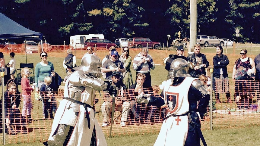 Two people in armour during a sword fight at a medieval festival in Tasmania.