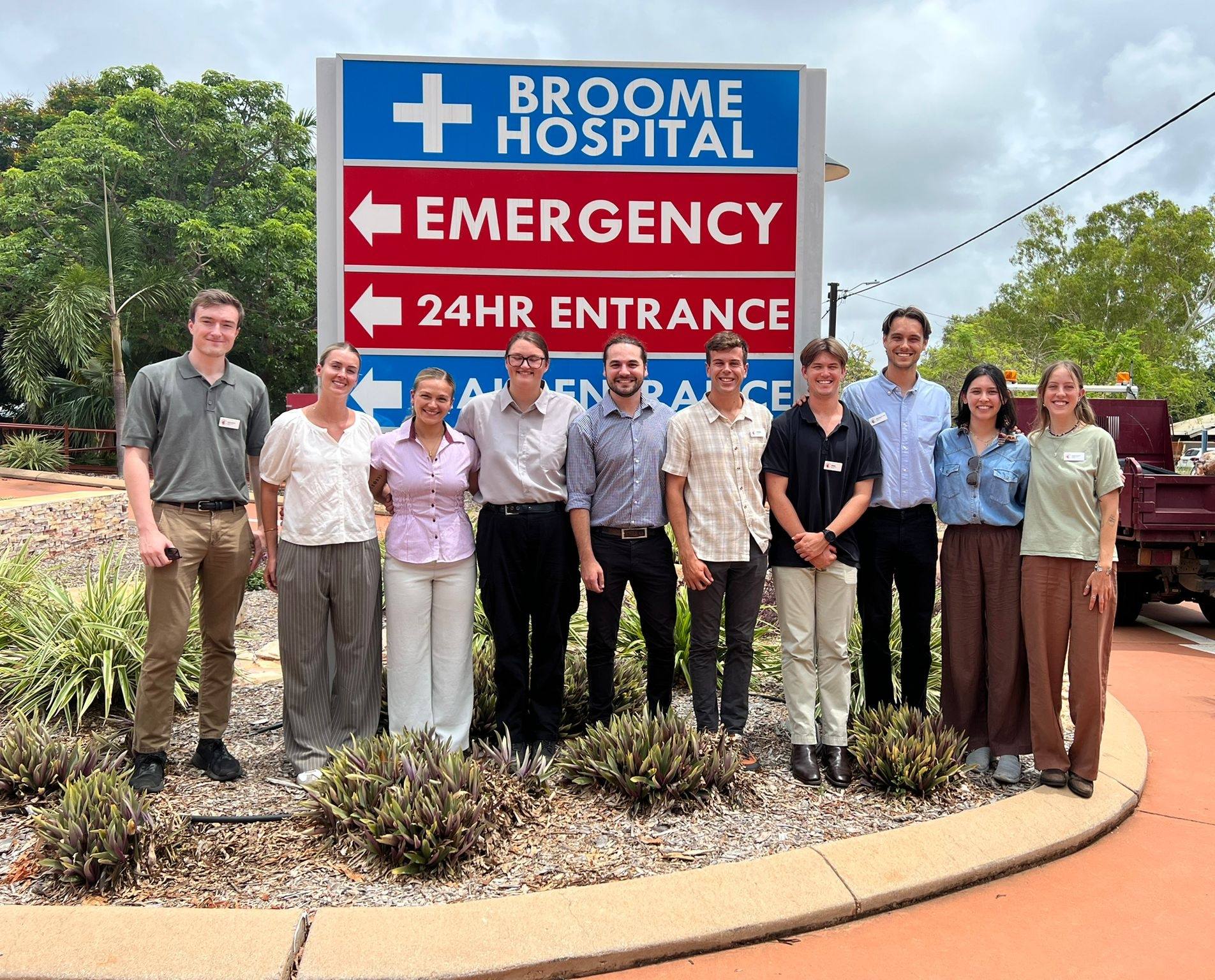 Student doctors standing at entrance to a hospital.  