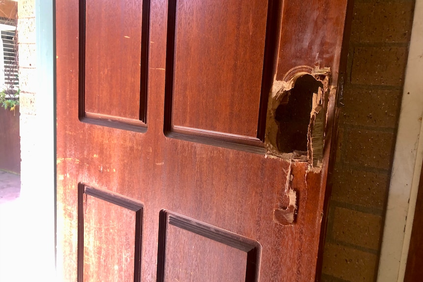 The handle of the door is completely missing in a wooden door.