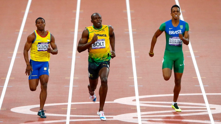 Usain Bolt cruises over the finish line ahead ofAlex Quinonez (L) and Aldemir da Silva Junior.