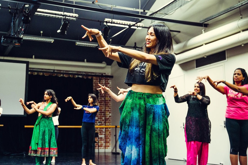 Andrea Lam leads a Bollywood dance with a group at her Brisbane studio.