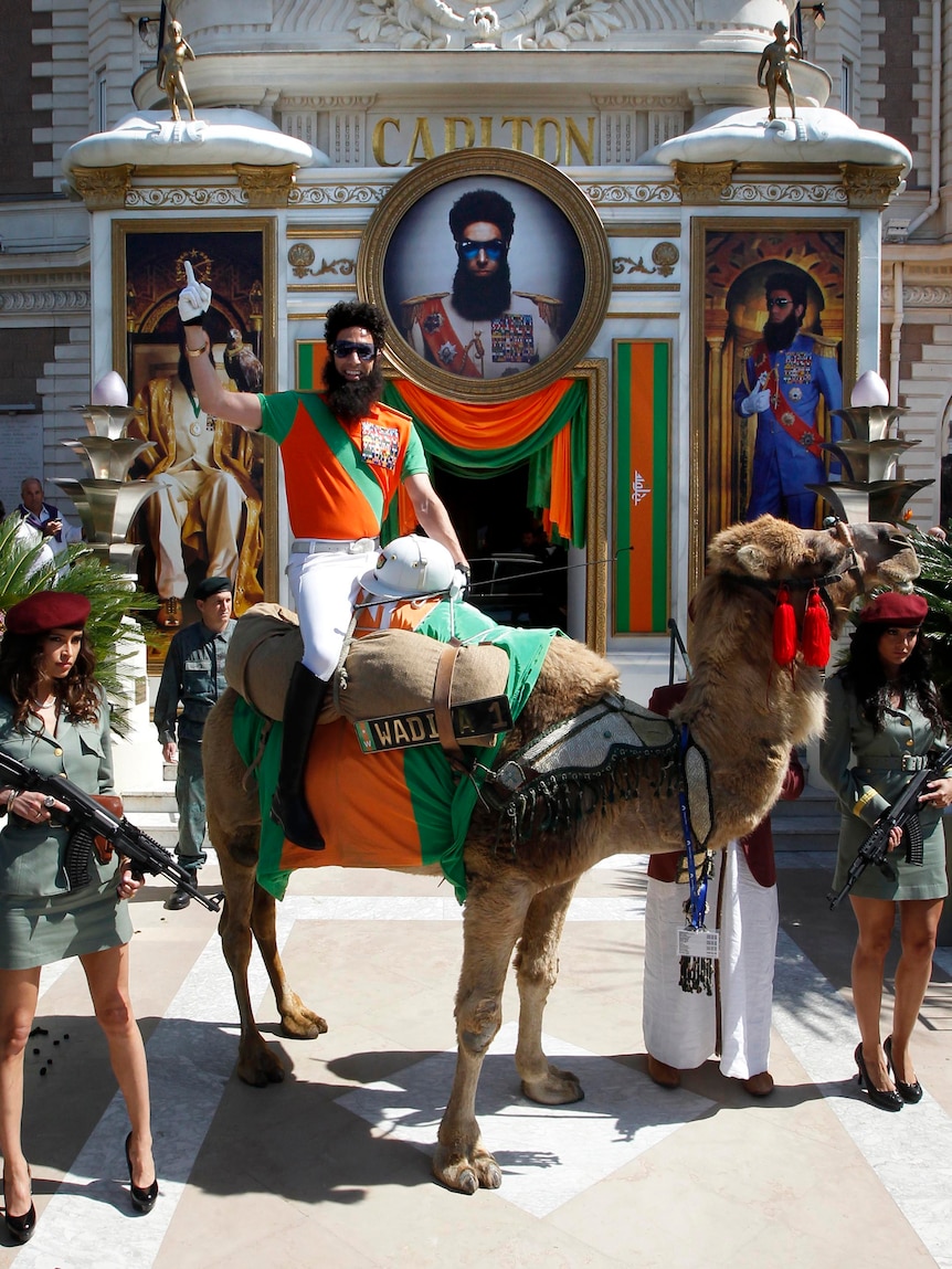 Sacha Baron Cohen sits on a camel during a photocall for The Dictator at the Cannes Film Festival.