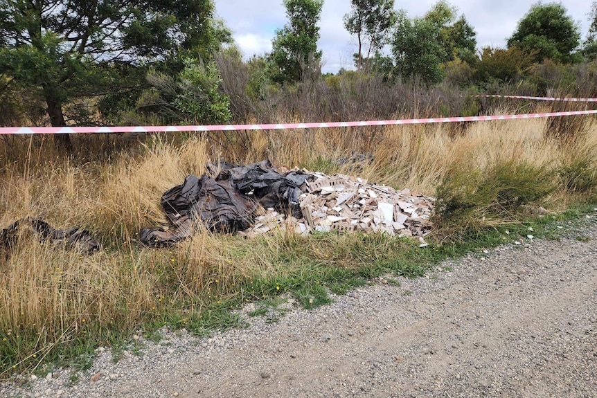 a cordoned-off area of rubbish dump