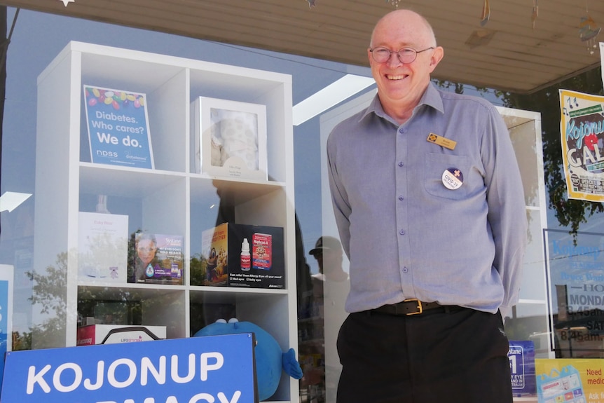 a  man stands in front of a shop