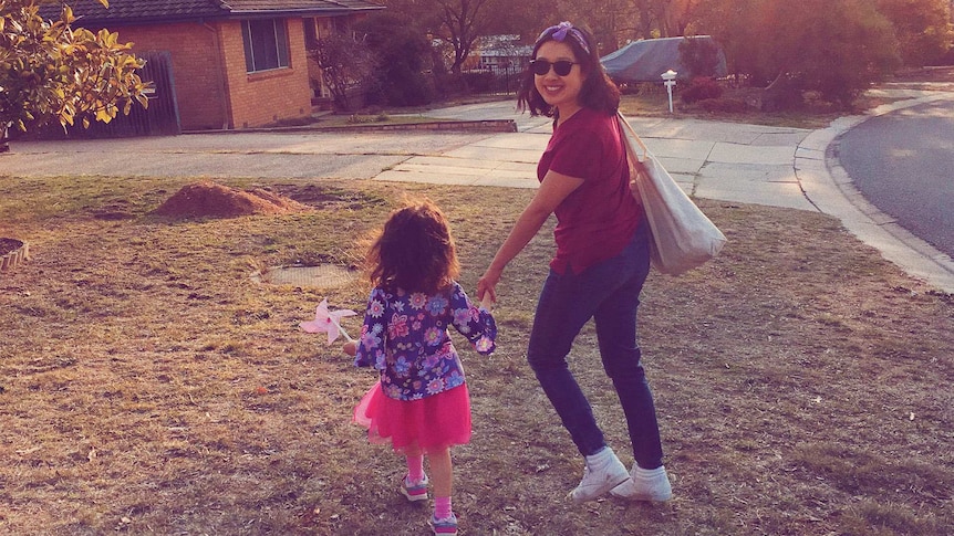 Carla Gee pictured with her daughter outside a suburban brick house