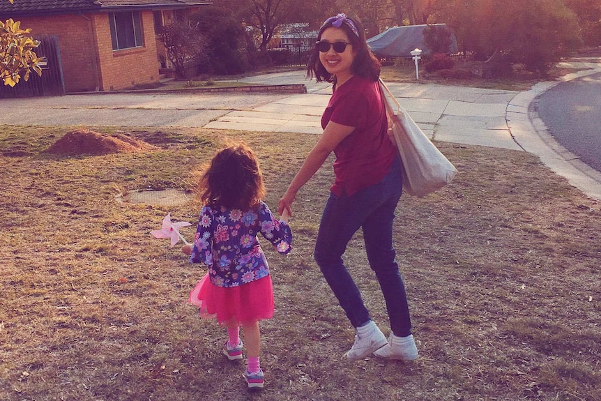 Carla Gee pictured with her daughter outside a suburban brick house