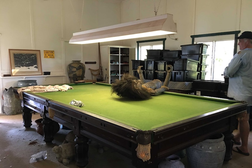 Cockatoo Island's new co-owner Dean Kemp standing with snooker table and decorations at games room