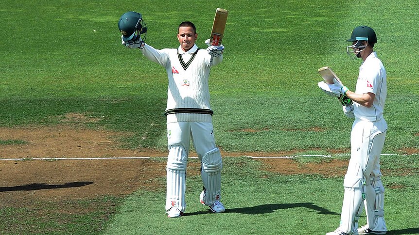 Australia's Adam Voges (R) looks on as Usman Khawaja celebrates a century against New Zealand.