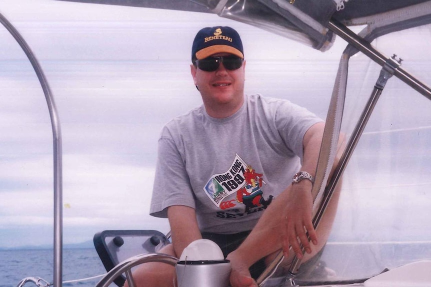 Tim Nicholls sits on a boat's deck in the Whitsundays in north Queensland on a bareback charter in 1994.