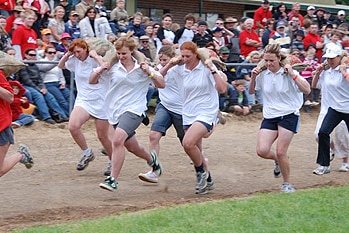 Women race with potato sacks in Robertson at the annual show.