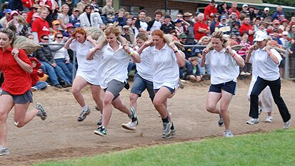 Women race with potato sacks in Robertson at the annual show.