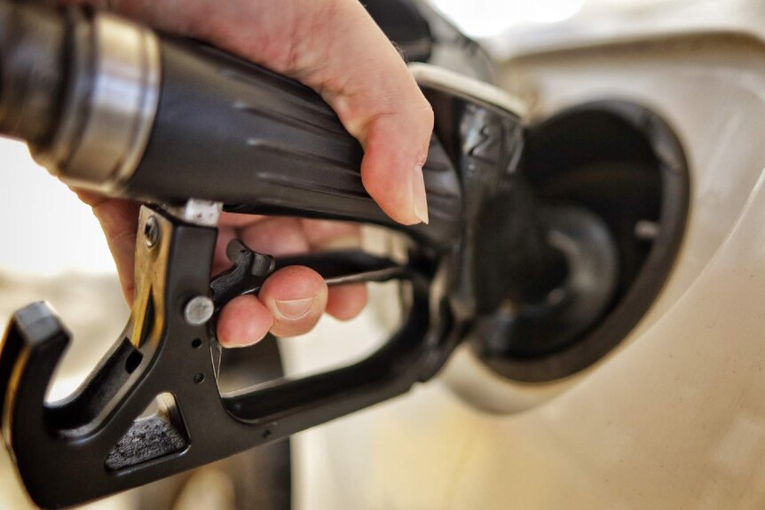 A generic image of a man putting petrol in a car.