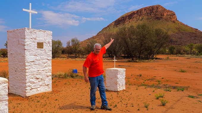 Ken Duncan pointing to the hill where the proposed 20-metre illuminated cross will be situated near Haasts Bluff, NT.