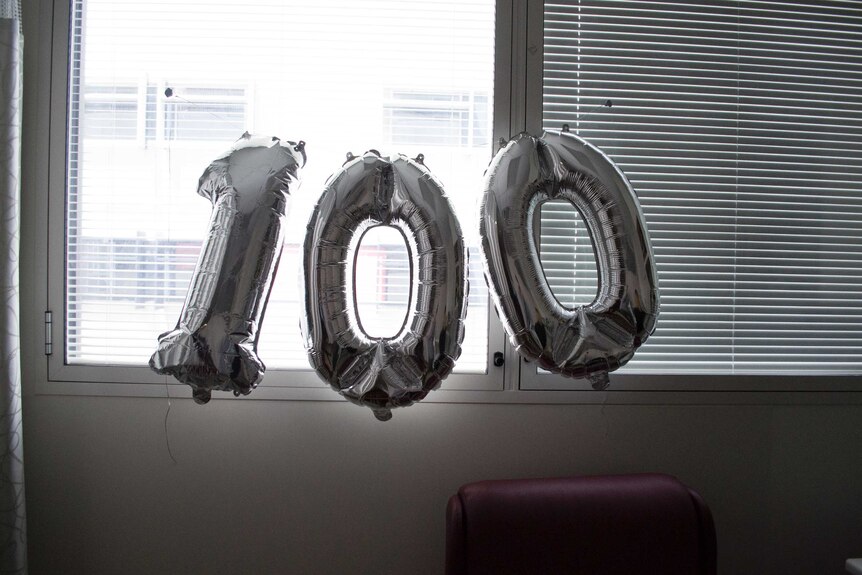 Balloons spell out "100" marking the 100-day-old milestone for Grayson.
