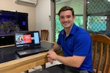 man in shirt sitting and smiling