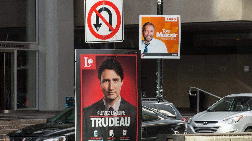 Posters for Canadian Liberal Party leader Justin Trudeau (L) and New Democratic Party leader Tom Mulcair