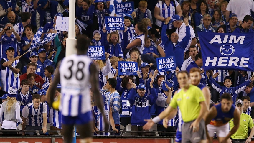 The Kangaroos' Majak Daw lines up for his first goal against Brisbane at Docklands.