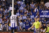 The Kangaroos' Majak Daw lines up for his first goal against Brisbane at Docklands.