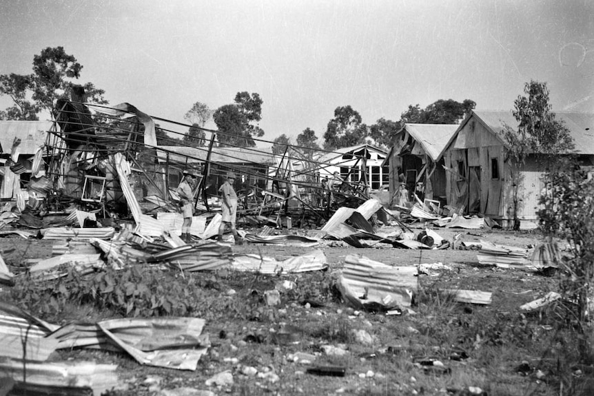 Soldiers inspect damage to defence buildings following a Japanese bombing raid