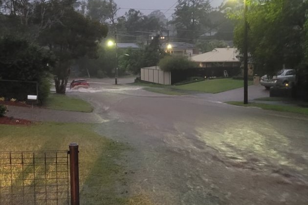 Floodwaters flow down a street.