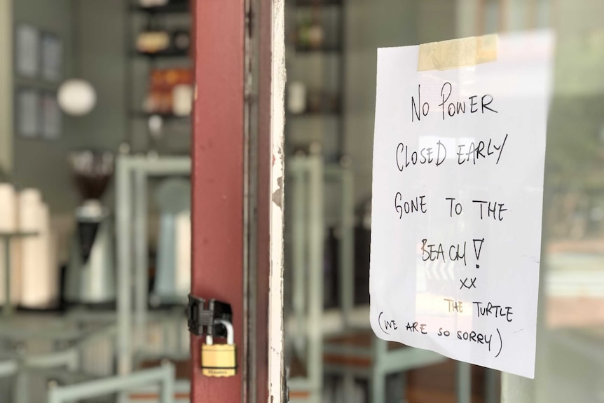 A sign on a shop in Elwood apologising to customers for closing early.