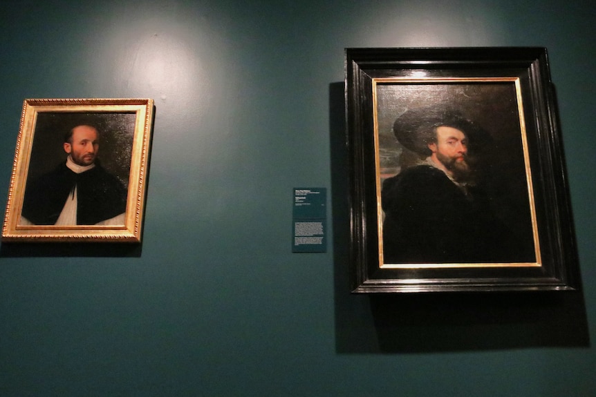Two historic portraits of men hang side-by-side