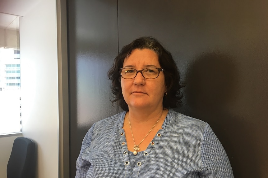 Jeanette Kerr stands in an office