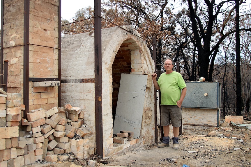 Steve Harrison stands next to the remains of his pottery building in Balmoral village.