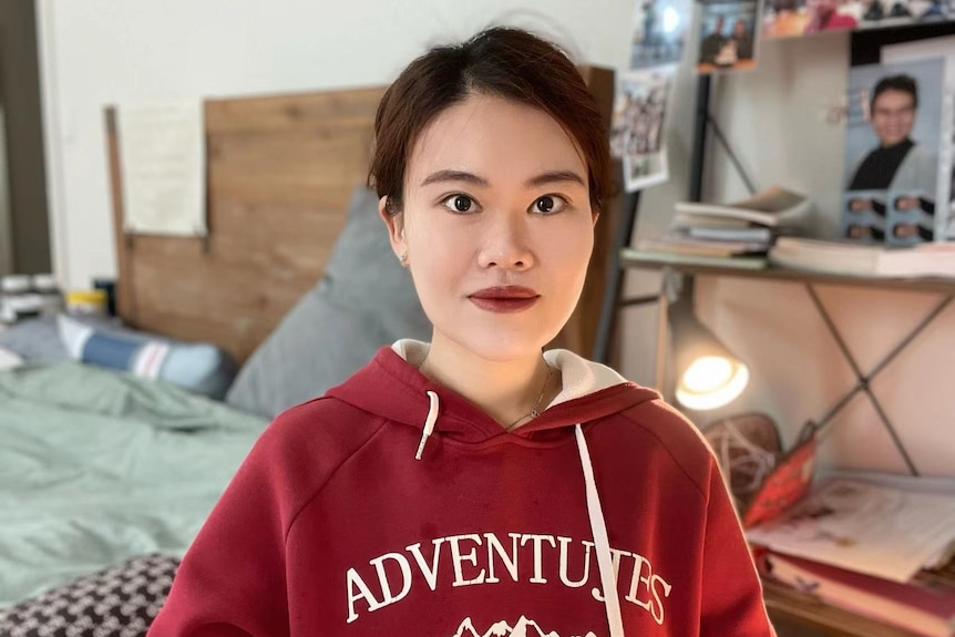 a Chinese girl dressed in a red hoodie 