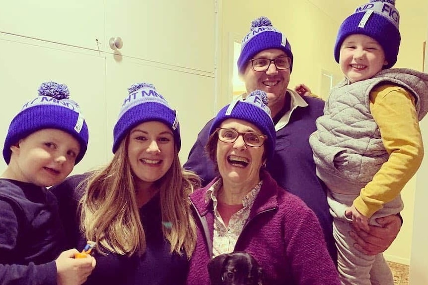 A family photo with Katie Donaldson, her mum, husband and kids all wearing beanies with 'Fight MND' on them