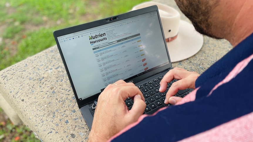 Man using a computer to access online auction