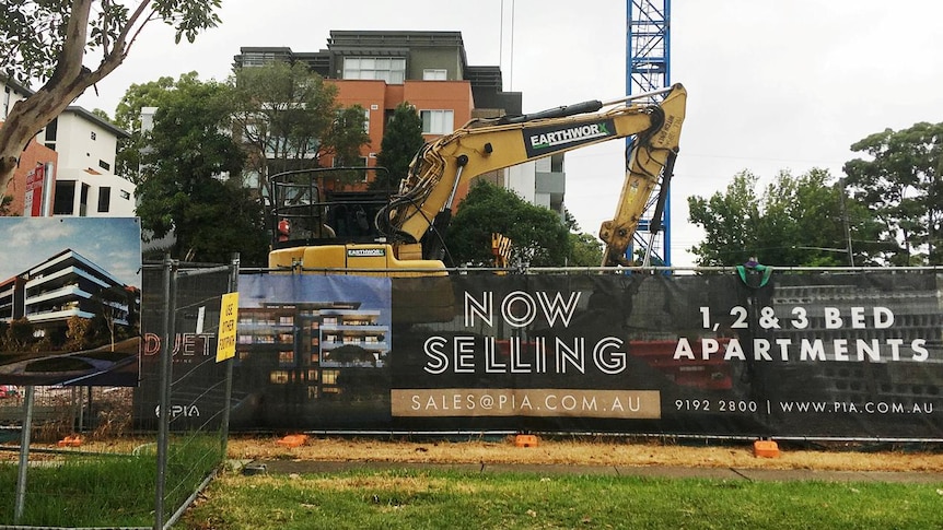 An excavator is parked at the construction site of an apartment block in the suburb of Epping, Sydney