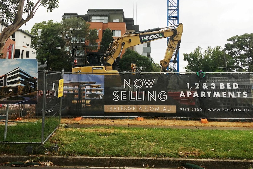 An excavator is parked at the construction site of an apartment block in the suburb of Epping, Sydney