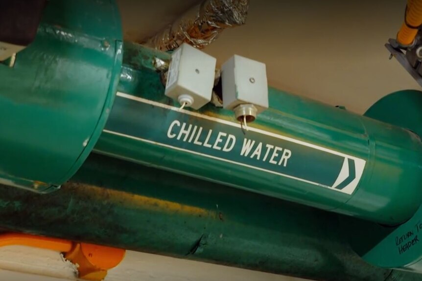 Large green piping with "chilled water" printed on the side in white font.