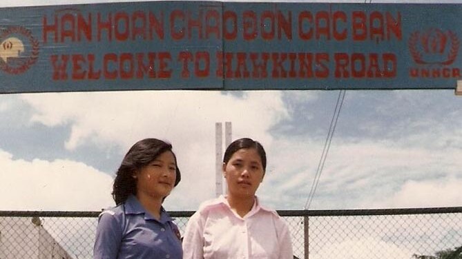 Two women from MG99 at the gates of Hawkins Road Camp in Singapore, 1981.