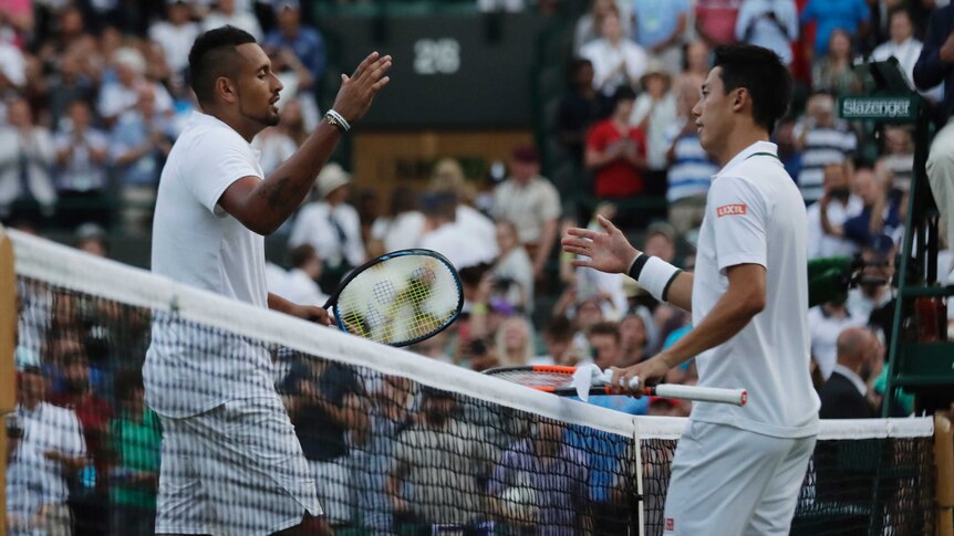 Kei Nishikori meets Nick Kyrgios at the net after winning their match at Wimbledon.